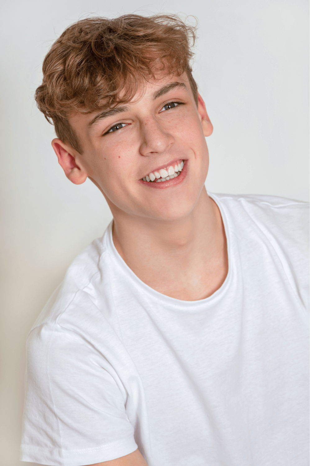 Smiling teenage boy with braces wearing a white t-shirt